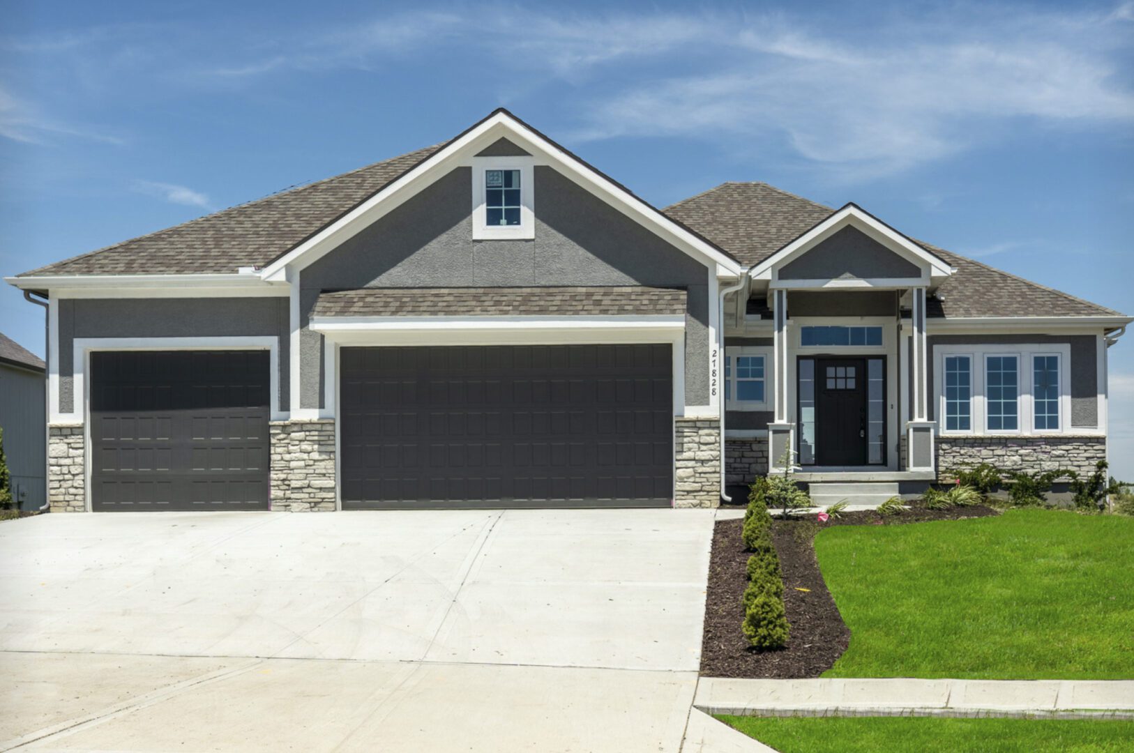The exterior of a home with a garage and driveway.
